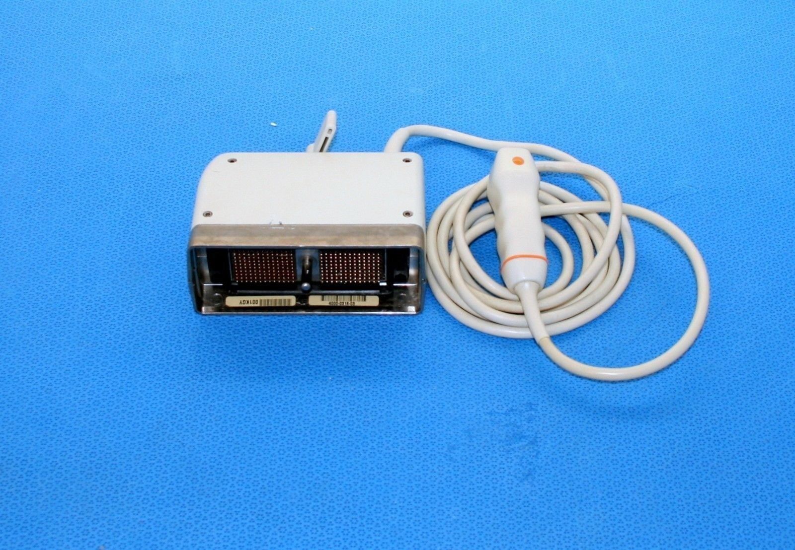 a small probe electronic device on a blue surface