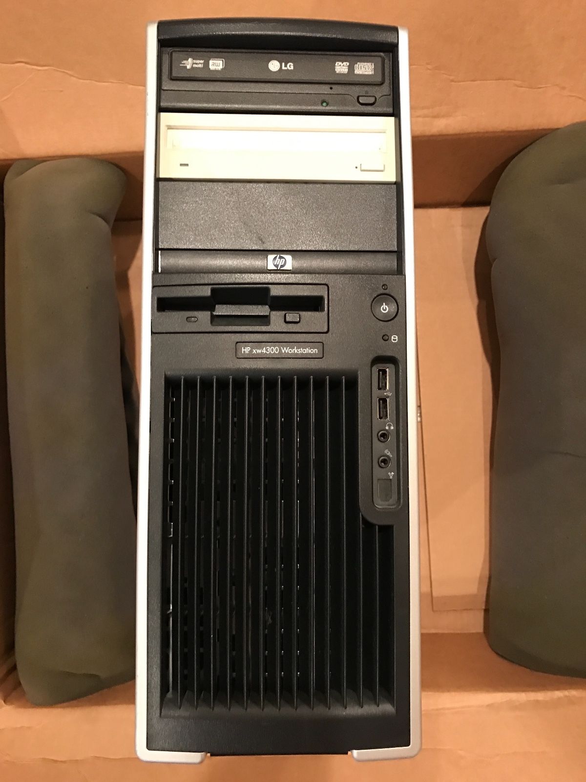 a desktop computer sitting on top of a cardboard box