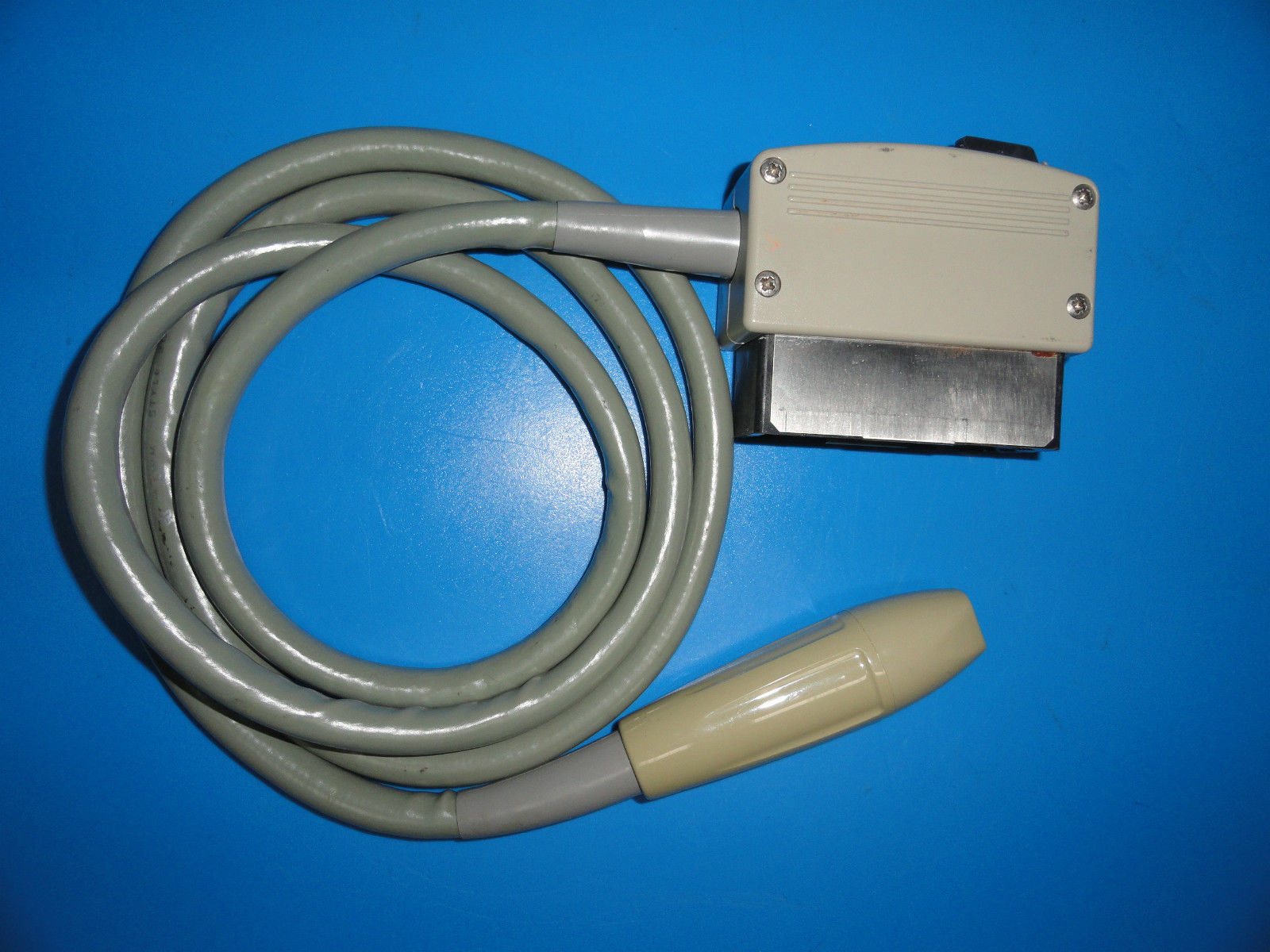 a cord connected to a device on a blue surface
