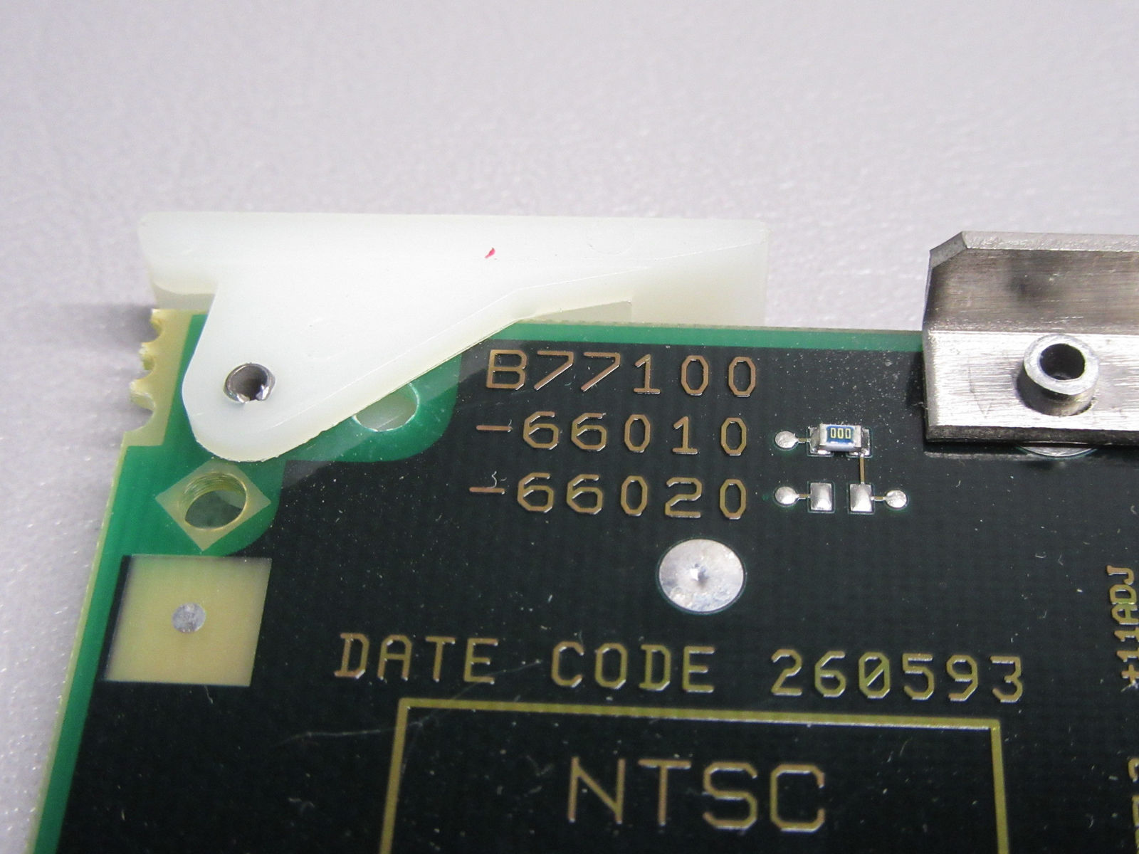 a close up of a motherboard with a piece of metal