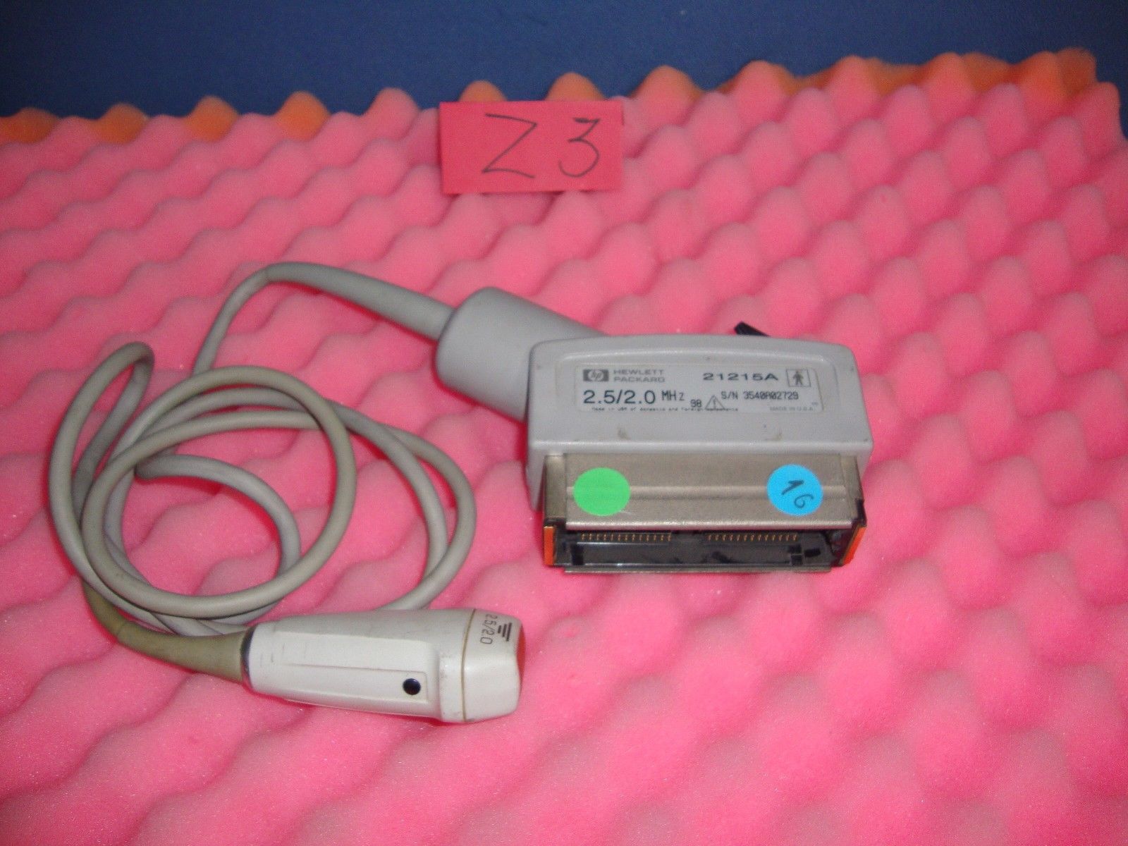 an electronic device is laying on a pink blanket