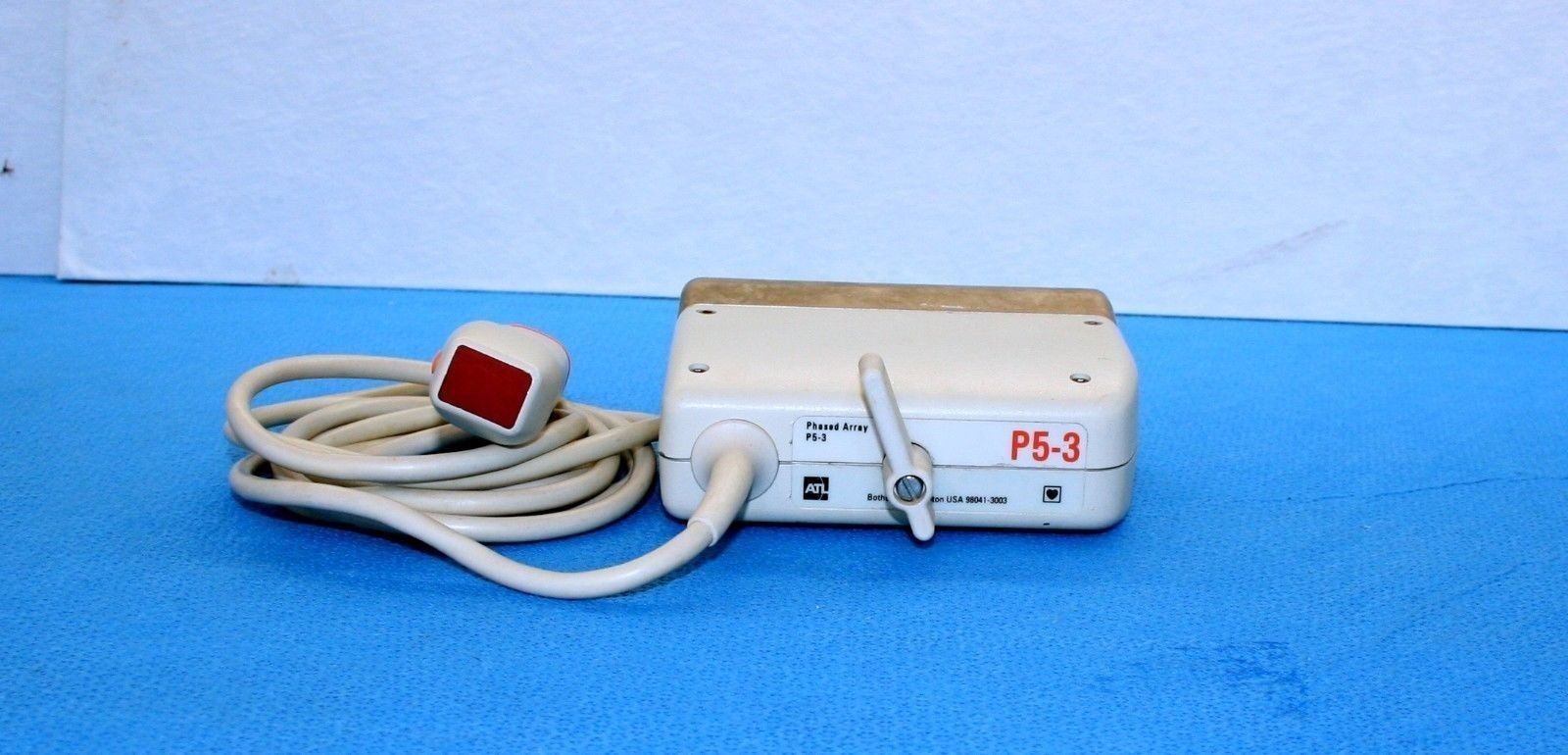 a medical device is laying on a blue surface