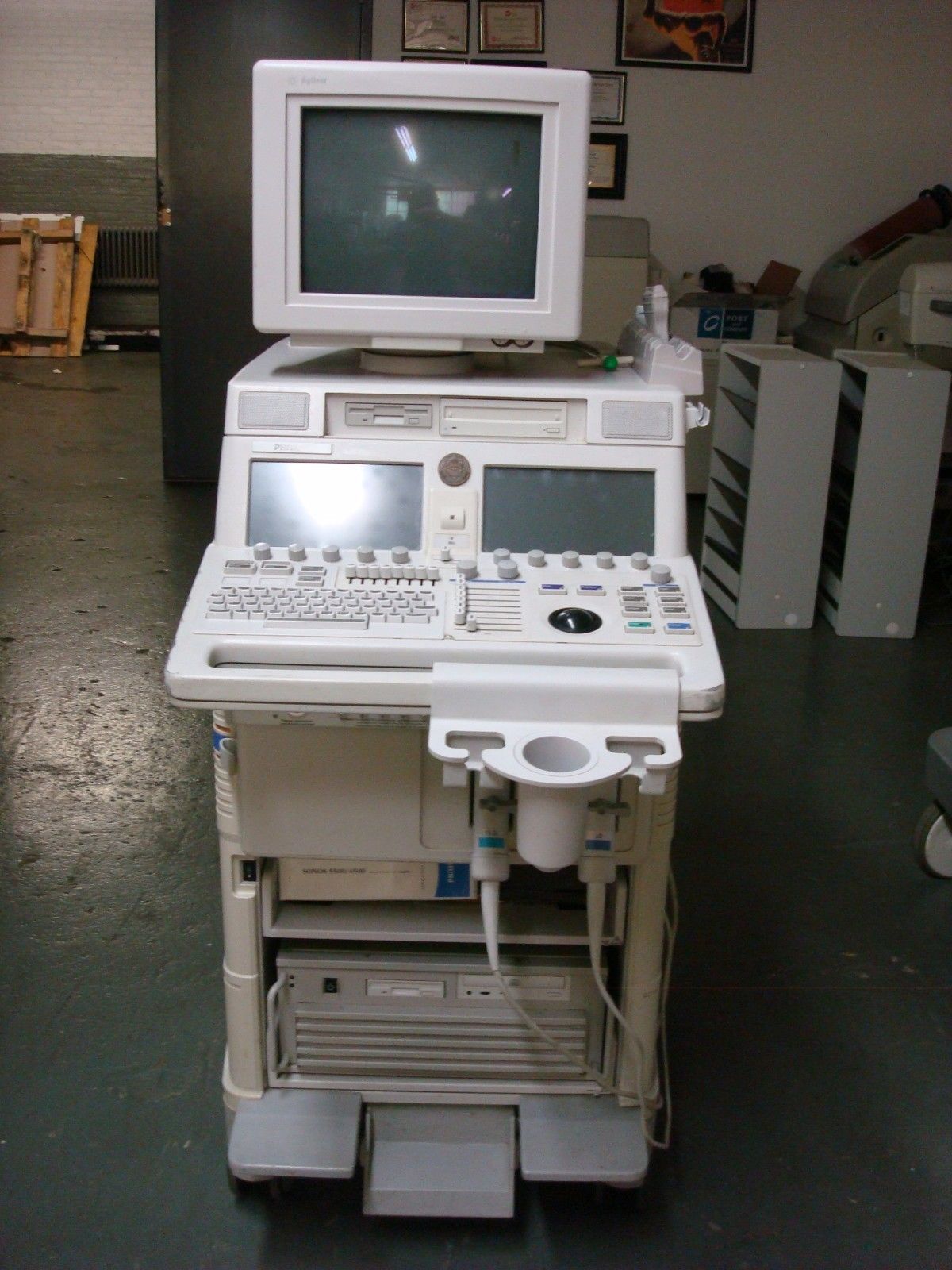 a white computer sitting on top of a cart
