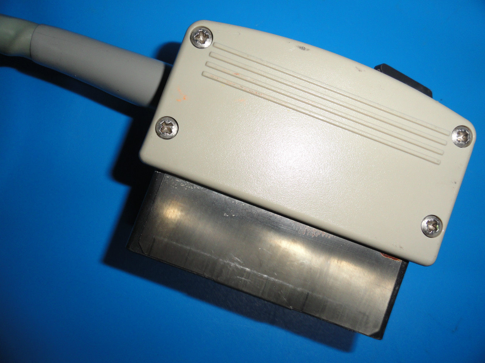 a close up of a metal object on a blue surface