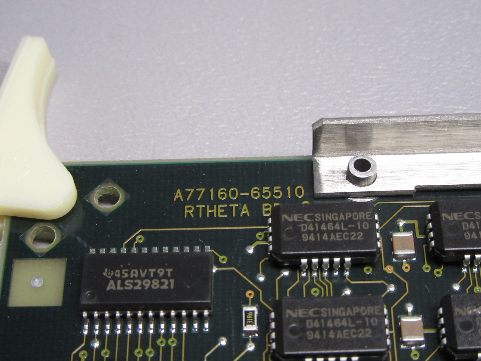 a close up of a computer board with a screw