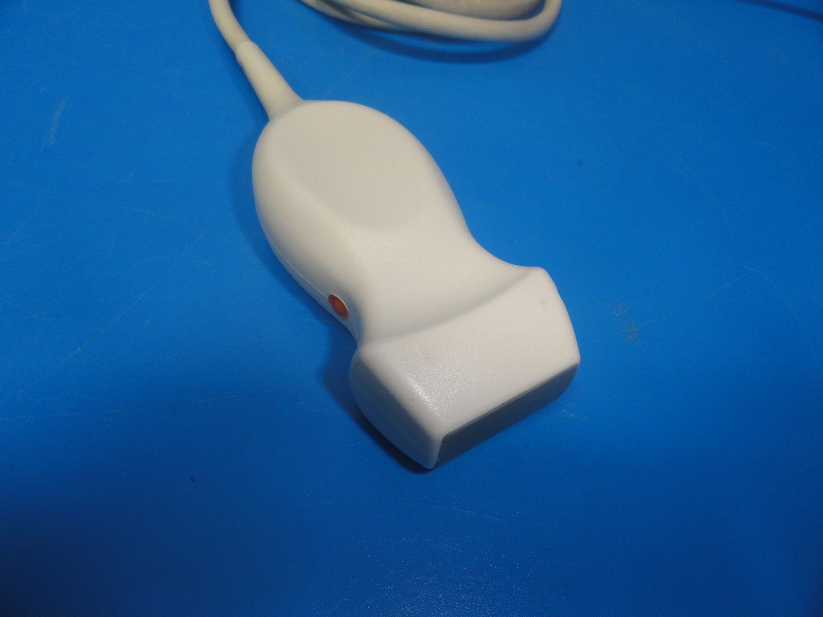 a white cord plugged into a computer mouse