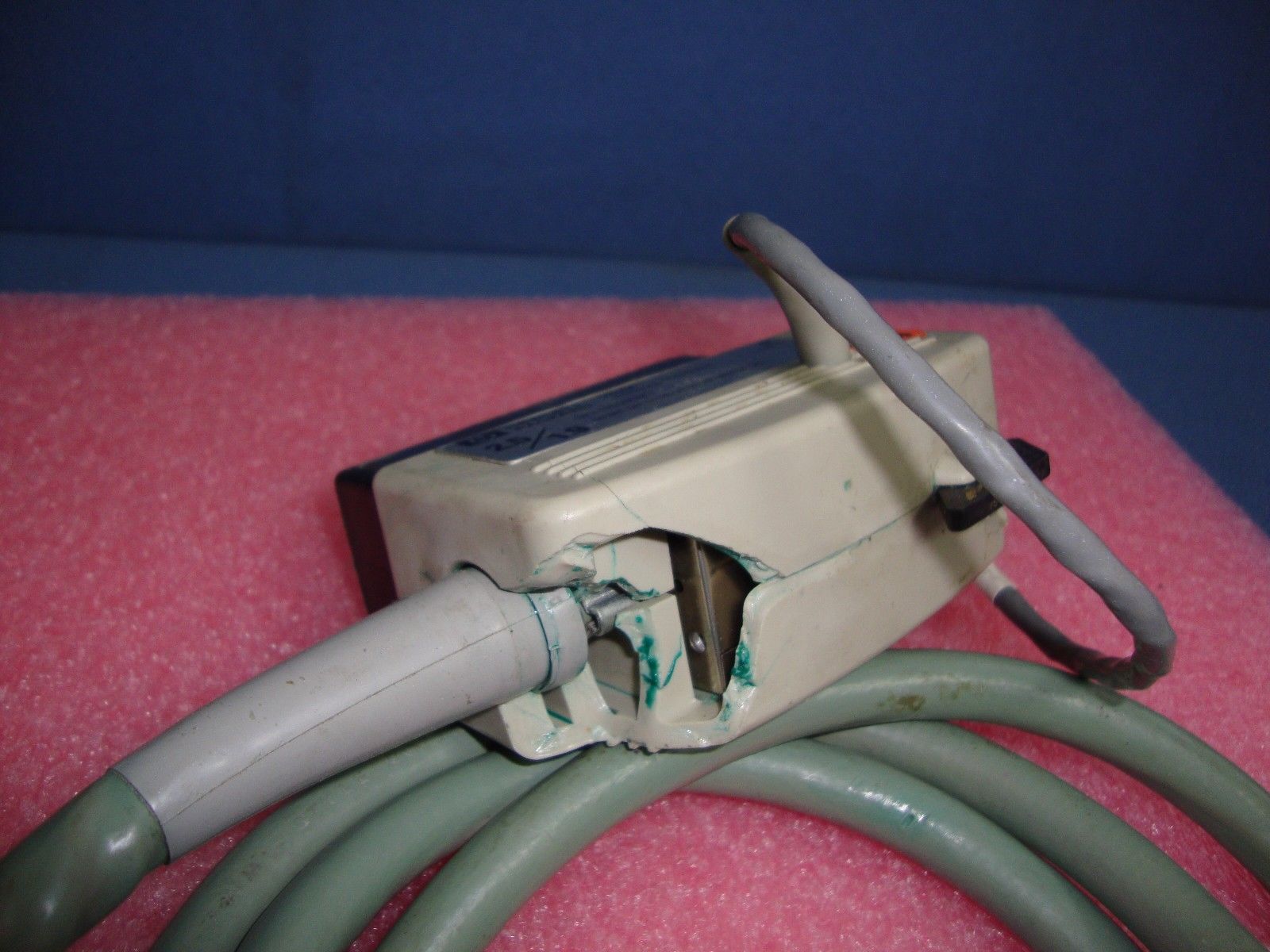 a cord connected to an electrical device on a pink surface
