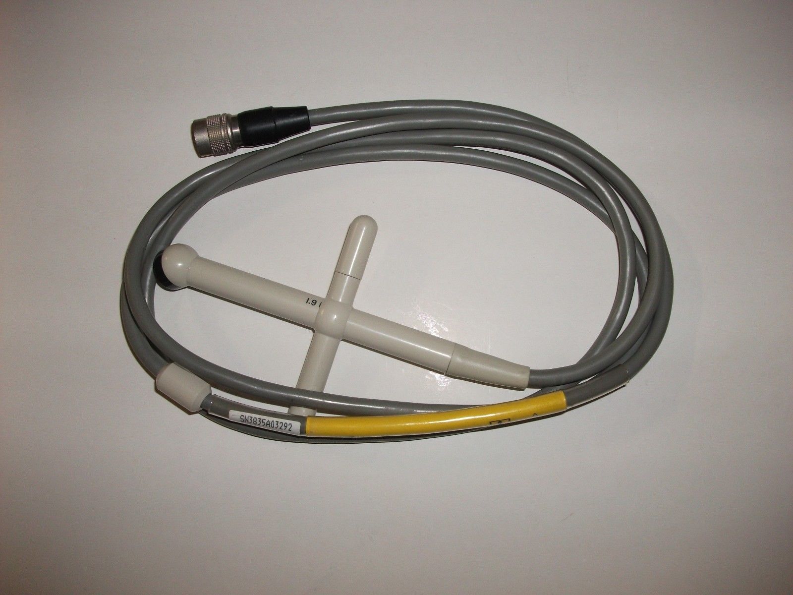 a yellow and gray hose connected to a white cord