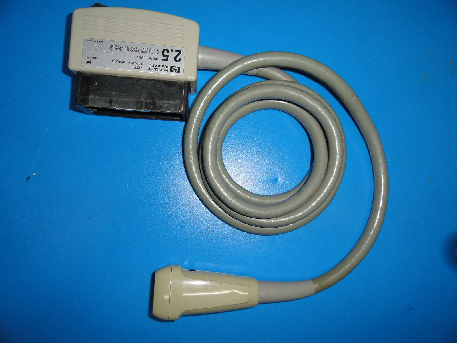 a white cord connected to a device on a blue surface
