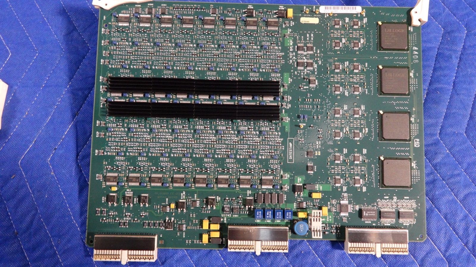 a close up of a computer motherboard on a blue surface