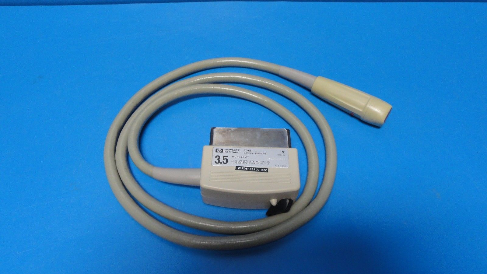 a white cord connected to a white device on a blue surface