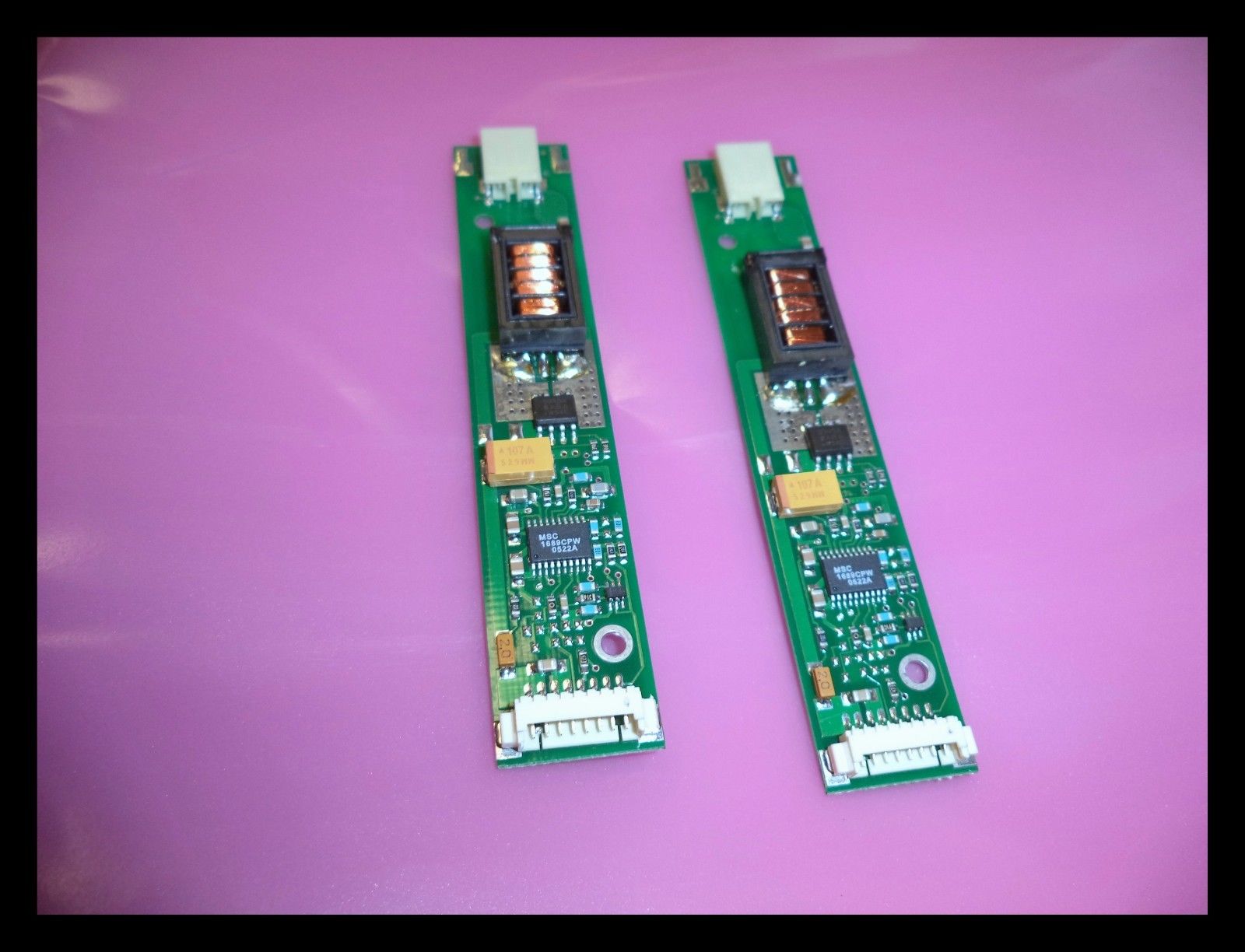 two electronic components sitting on top of a purple surface