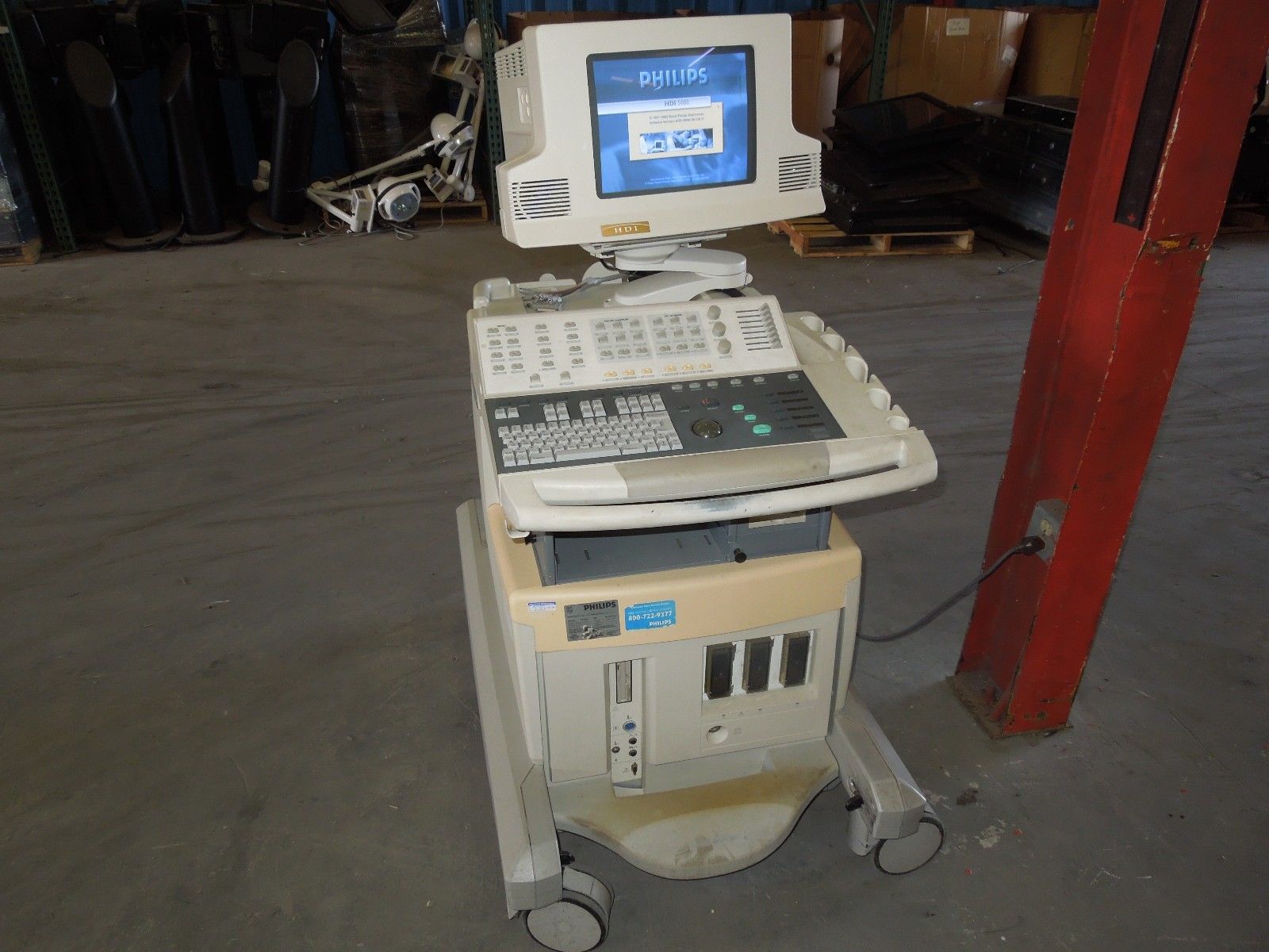a computer sitting on top of a cart in a warehouse