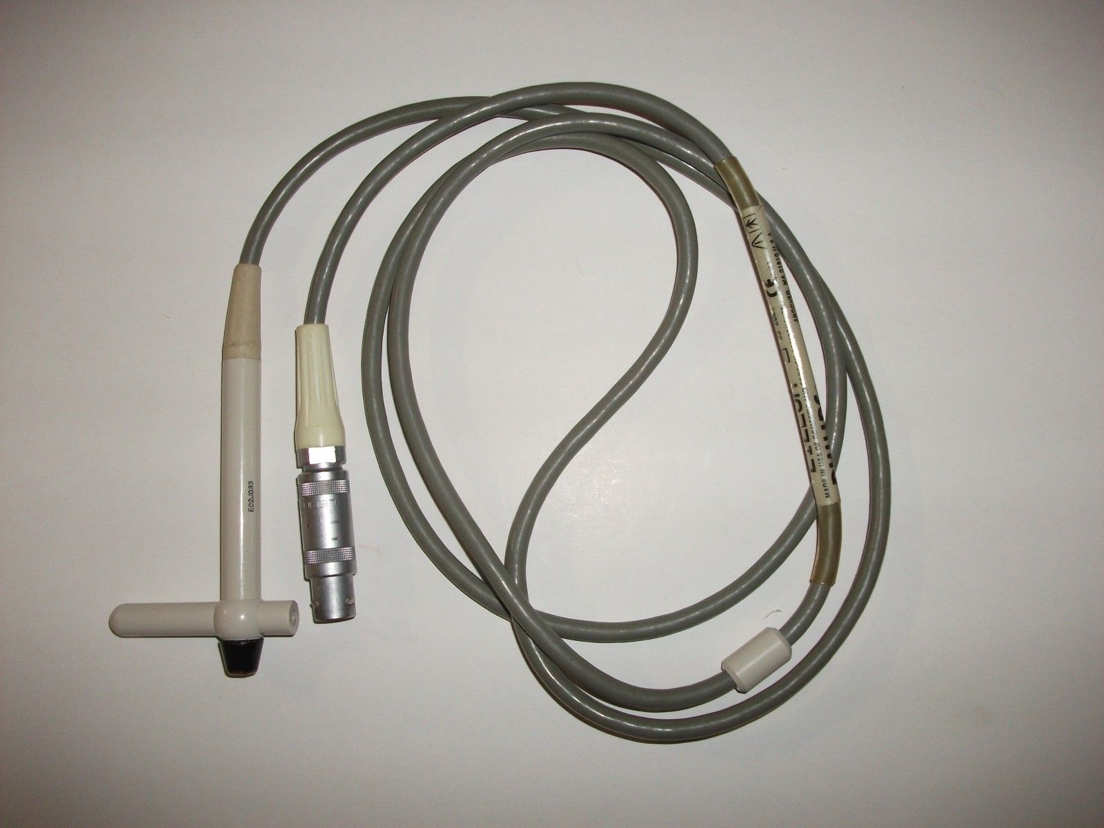 a probe and a cord on a white surface