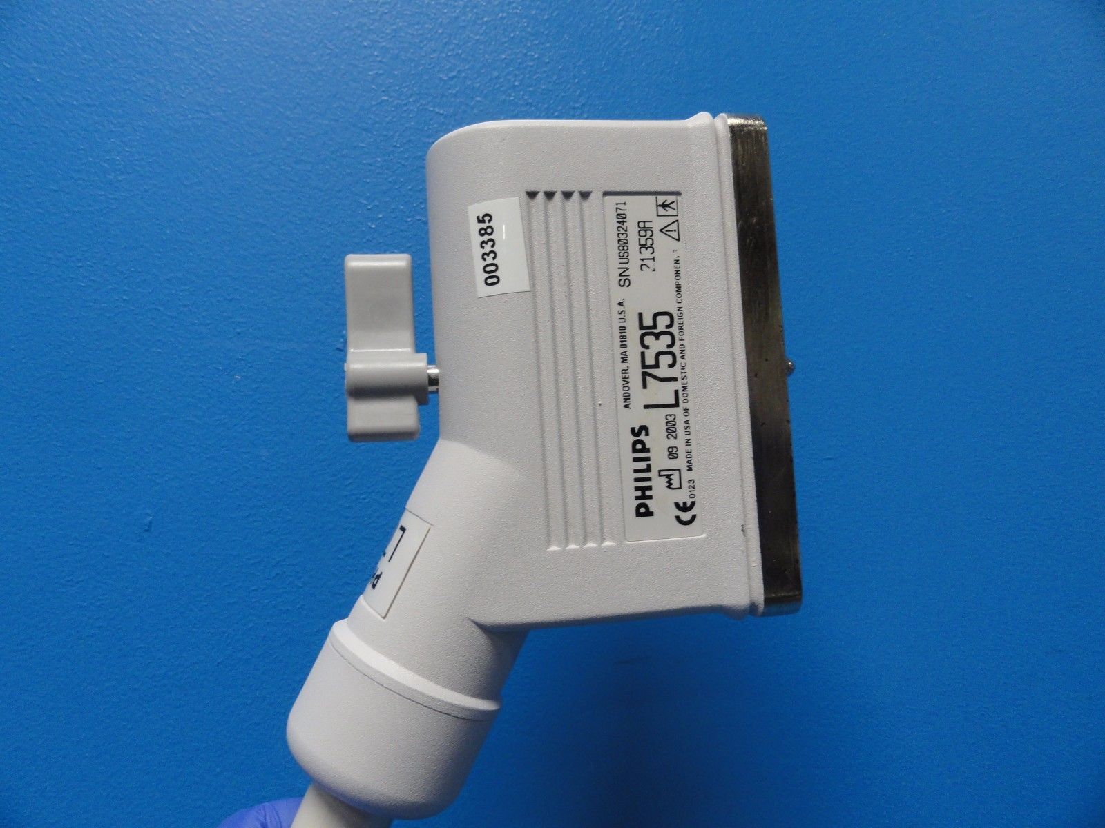 a close up of a white device on a blue wall