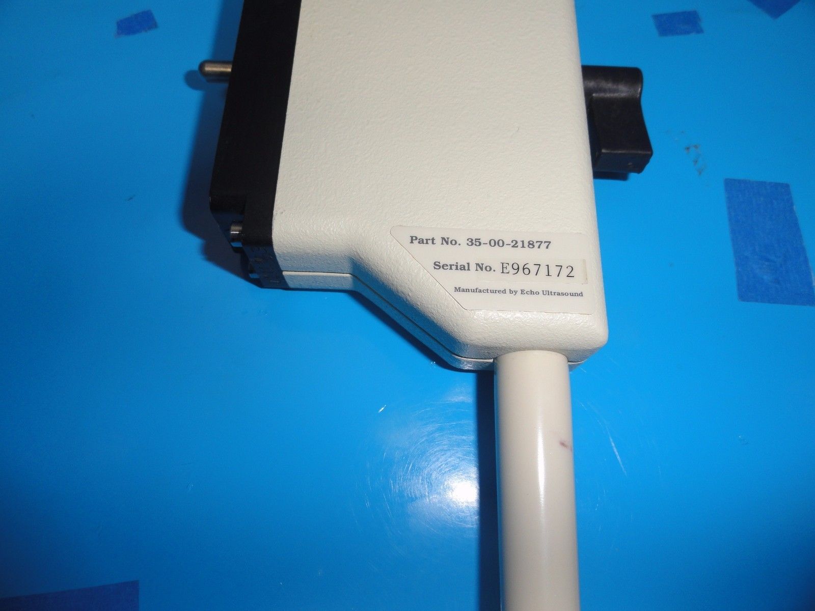 a white and black device on a blue surface