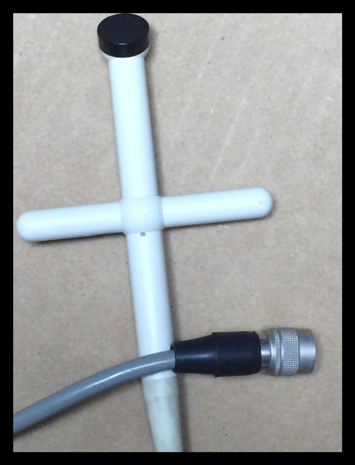 a white pipe connected to a black and white hose