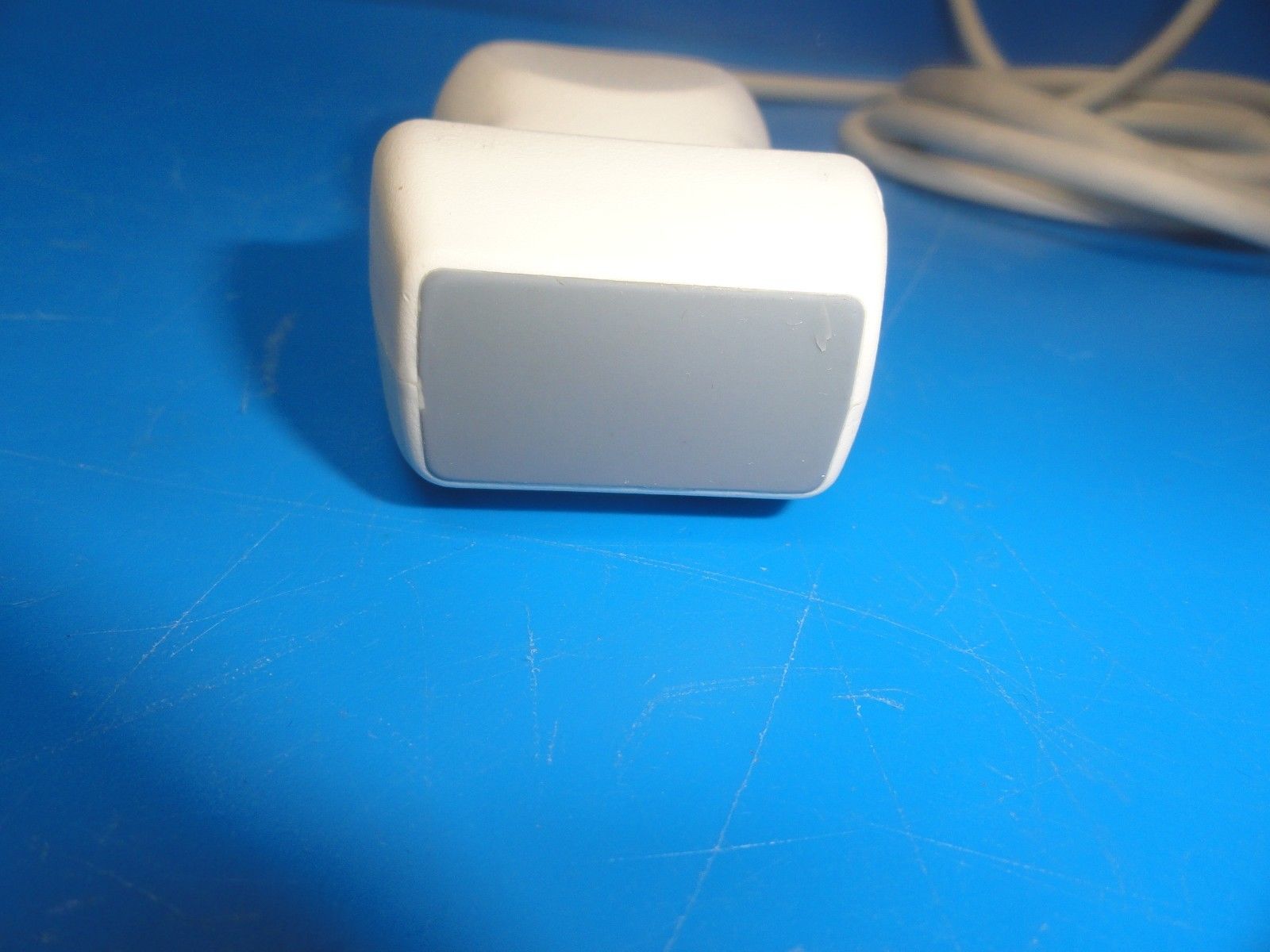 a white object sitting on top of a blue table