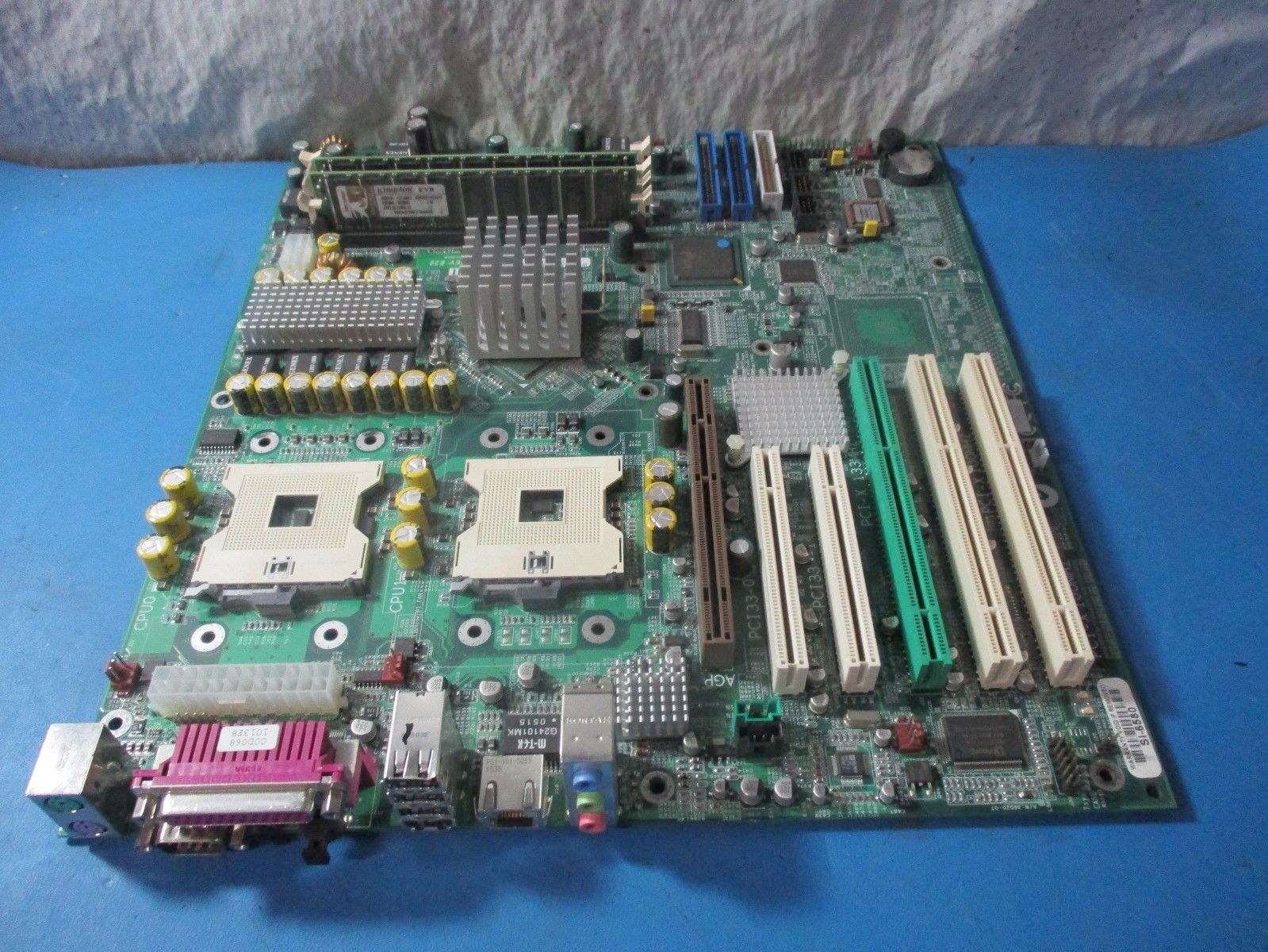 a computer motherboard sitting on a blue surface
