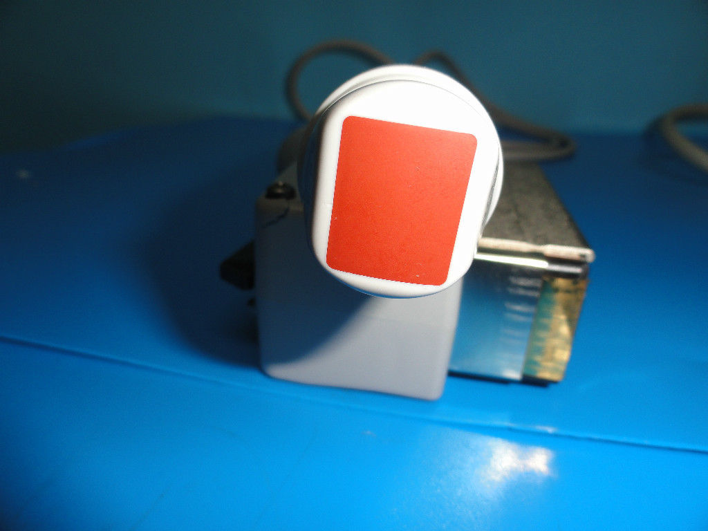 a red and white object sitting on top of a blue table