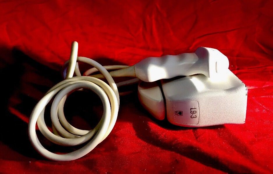 a couple of white cords sitting on top of a red blanket