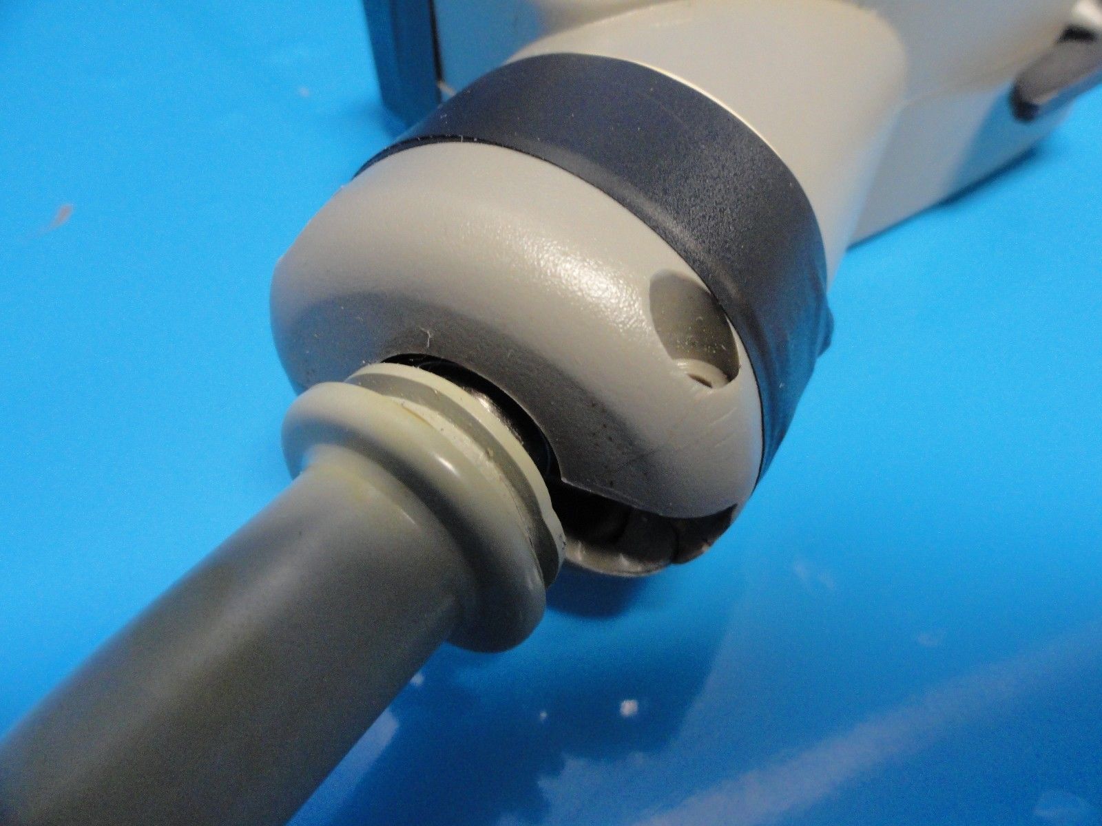 a close up of a white and black object on a blue surface