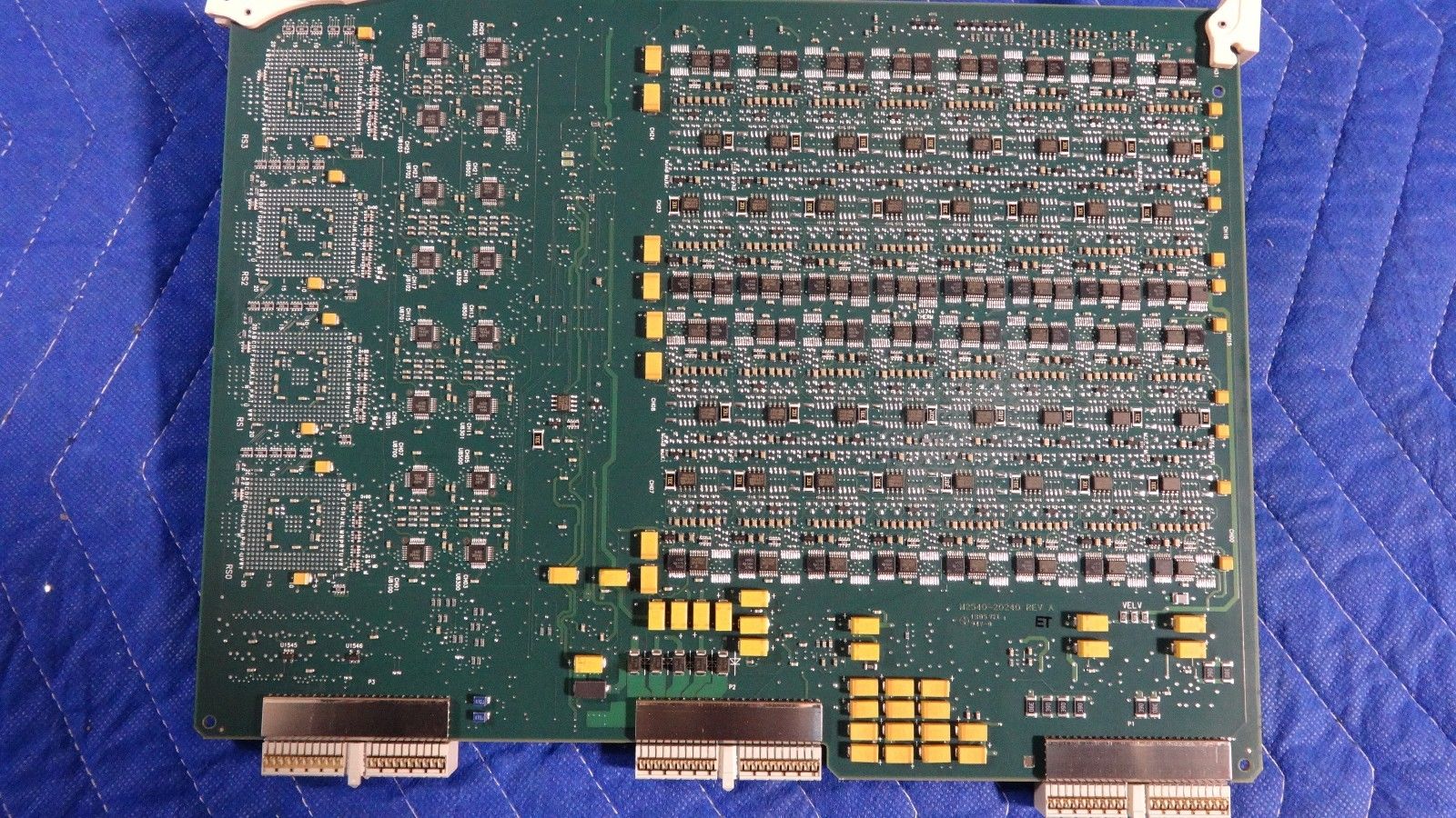 a close up of a computer board on a blue surface