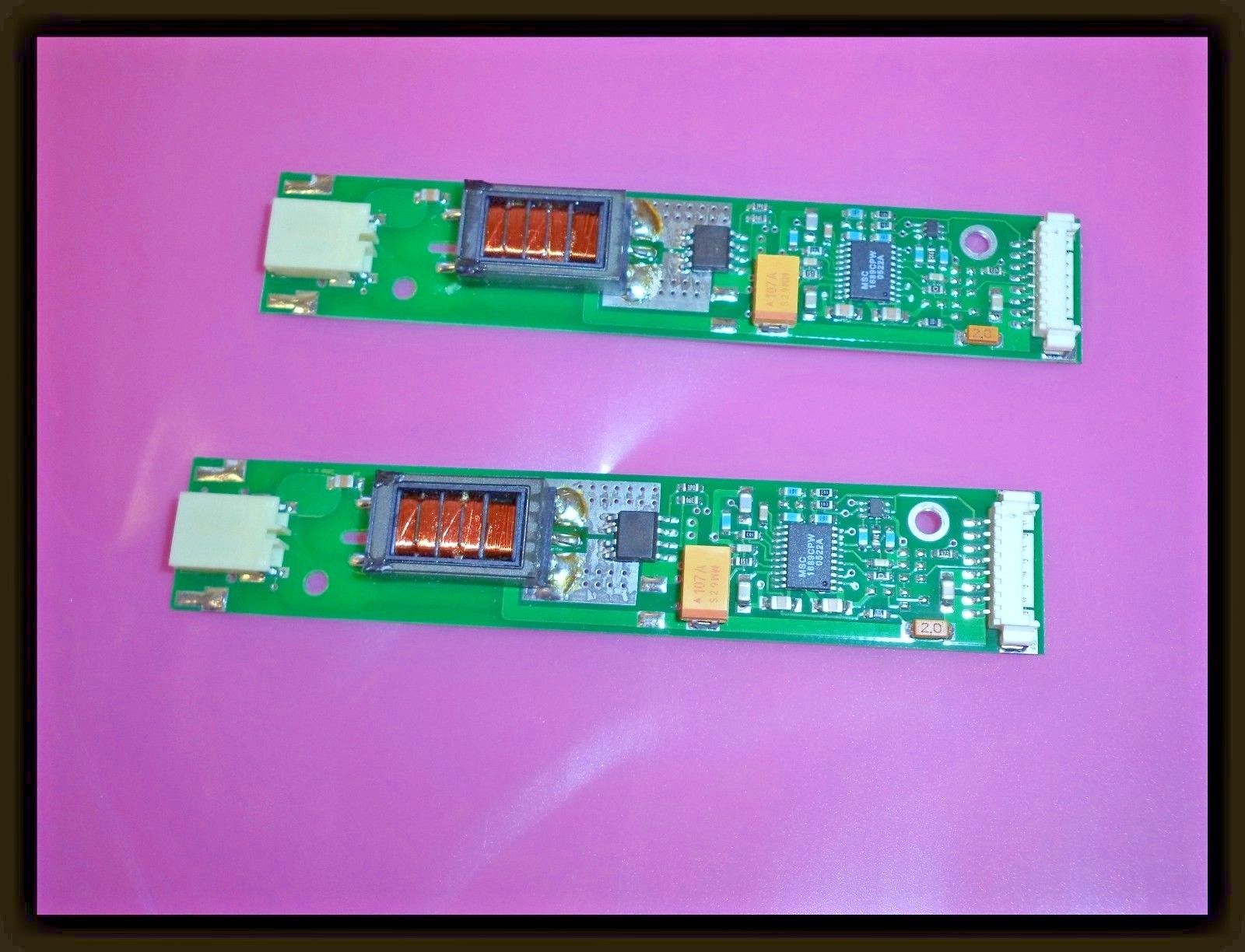 two electronic components sitting side by side on a pink surface
