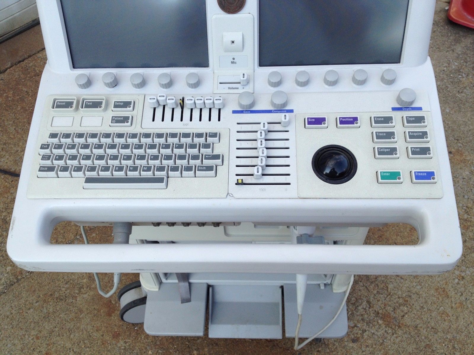a medical machine with two monitors on top of it