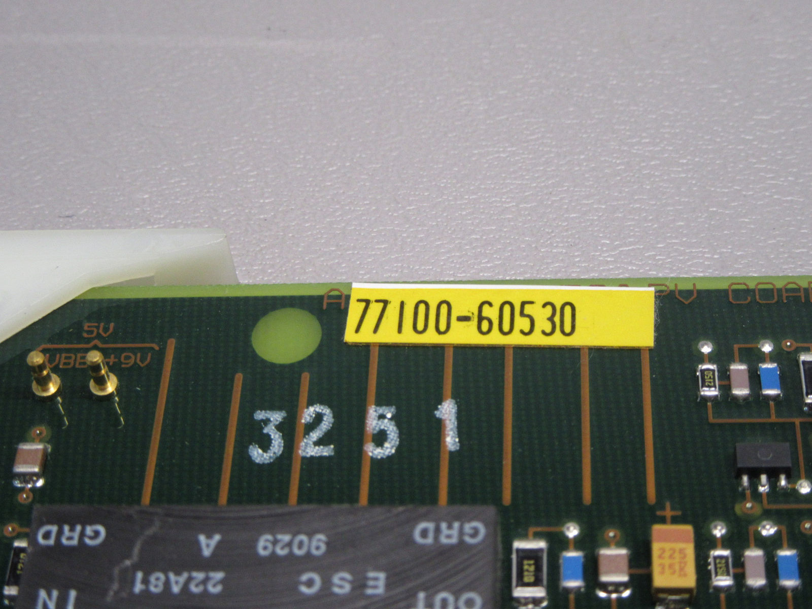 a close up of a circuit board with a yellow marker on it