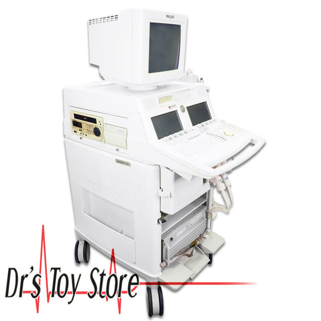 a white medical machine with two monitors on top of it