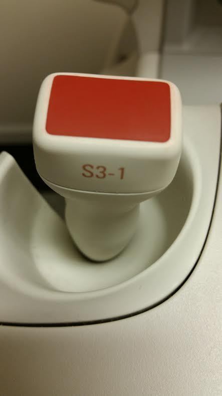 a close up of a red and white probe head