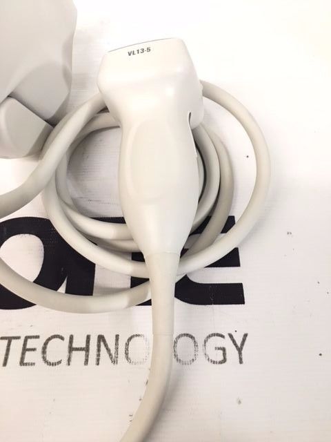 a white cord plugged into a white wall charger