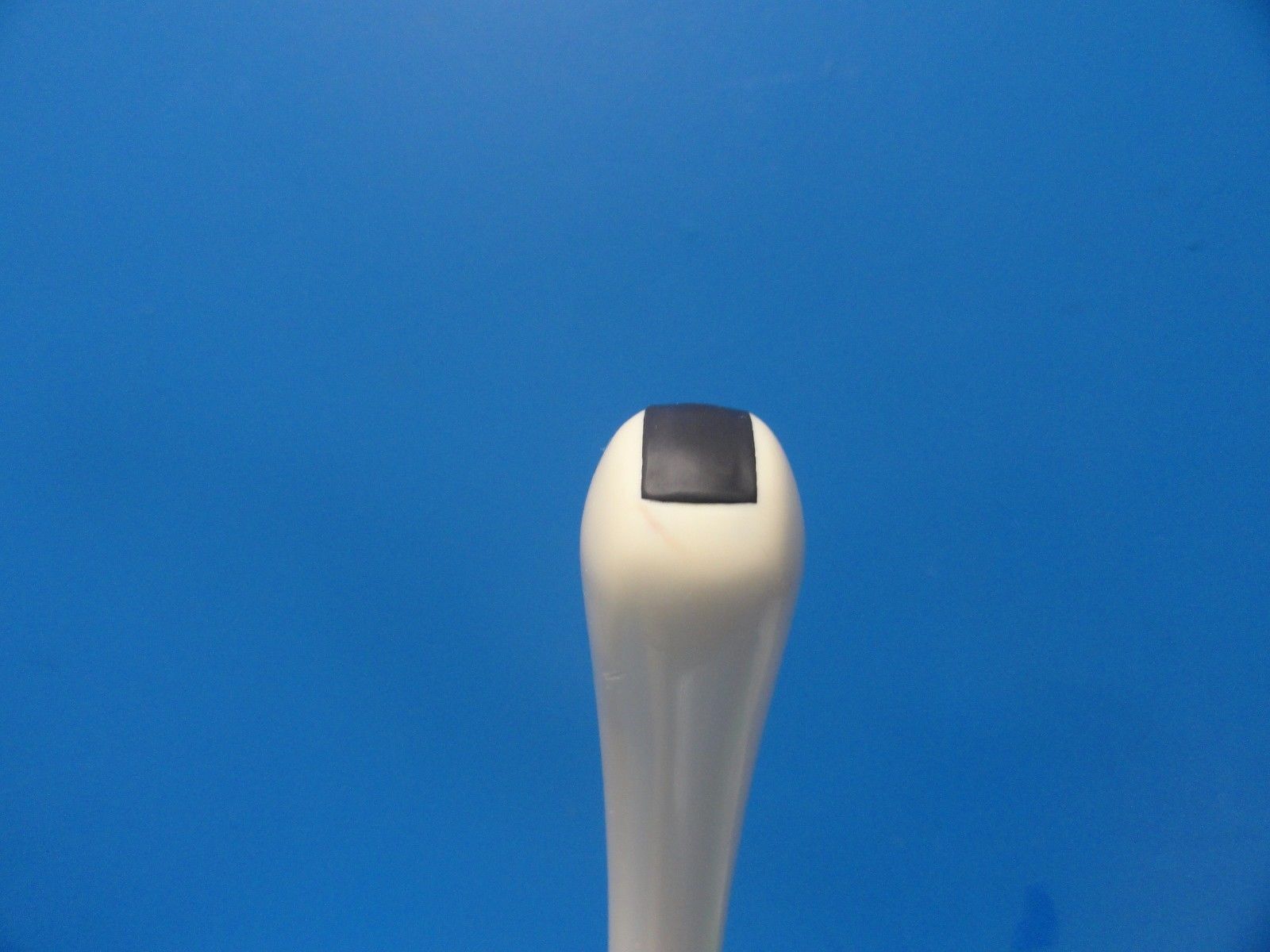 a close up of a white object on a blue background
