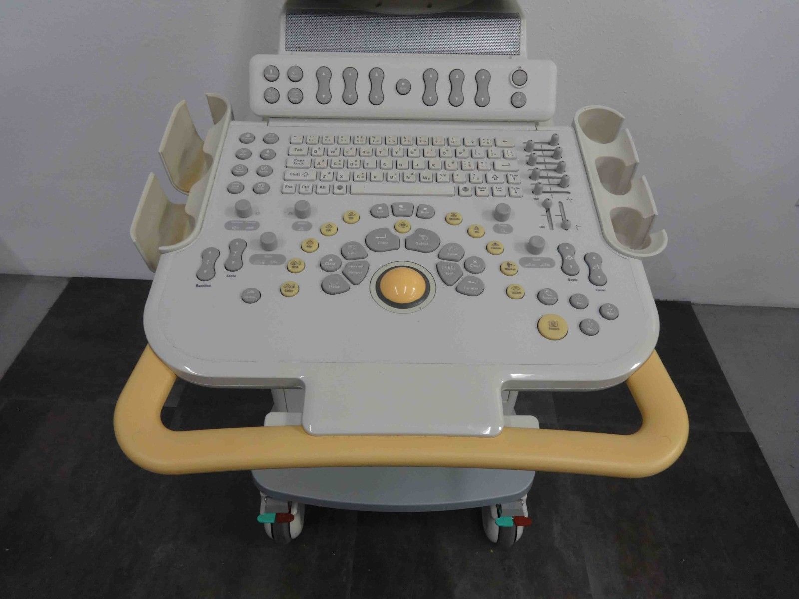 a white and yellow computer sitting on top of a table