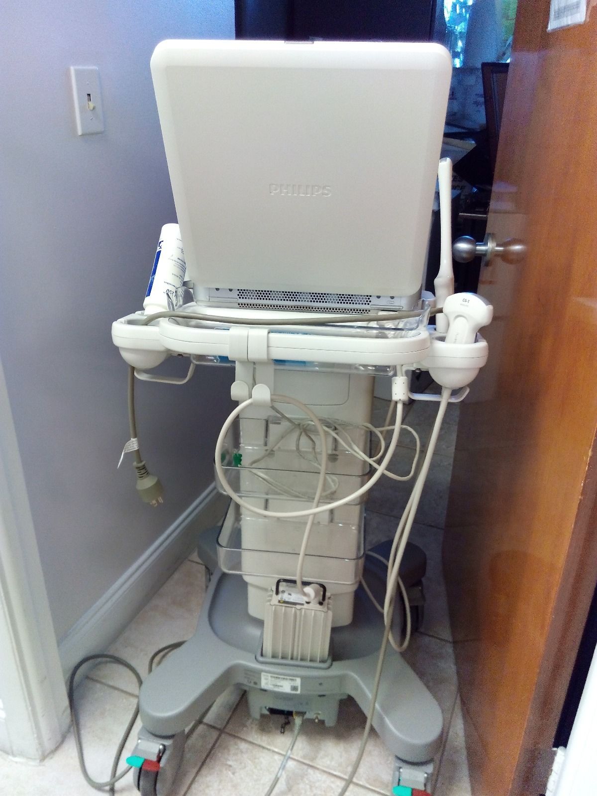 a laptop computer sitting on top of a medical cart