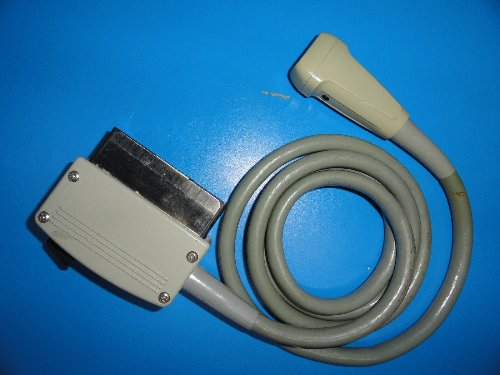 a cable connected to a device on a blue surface