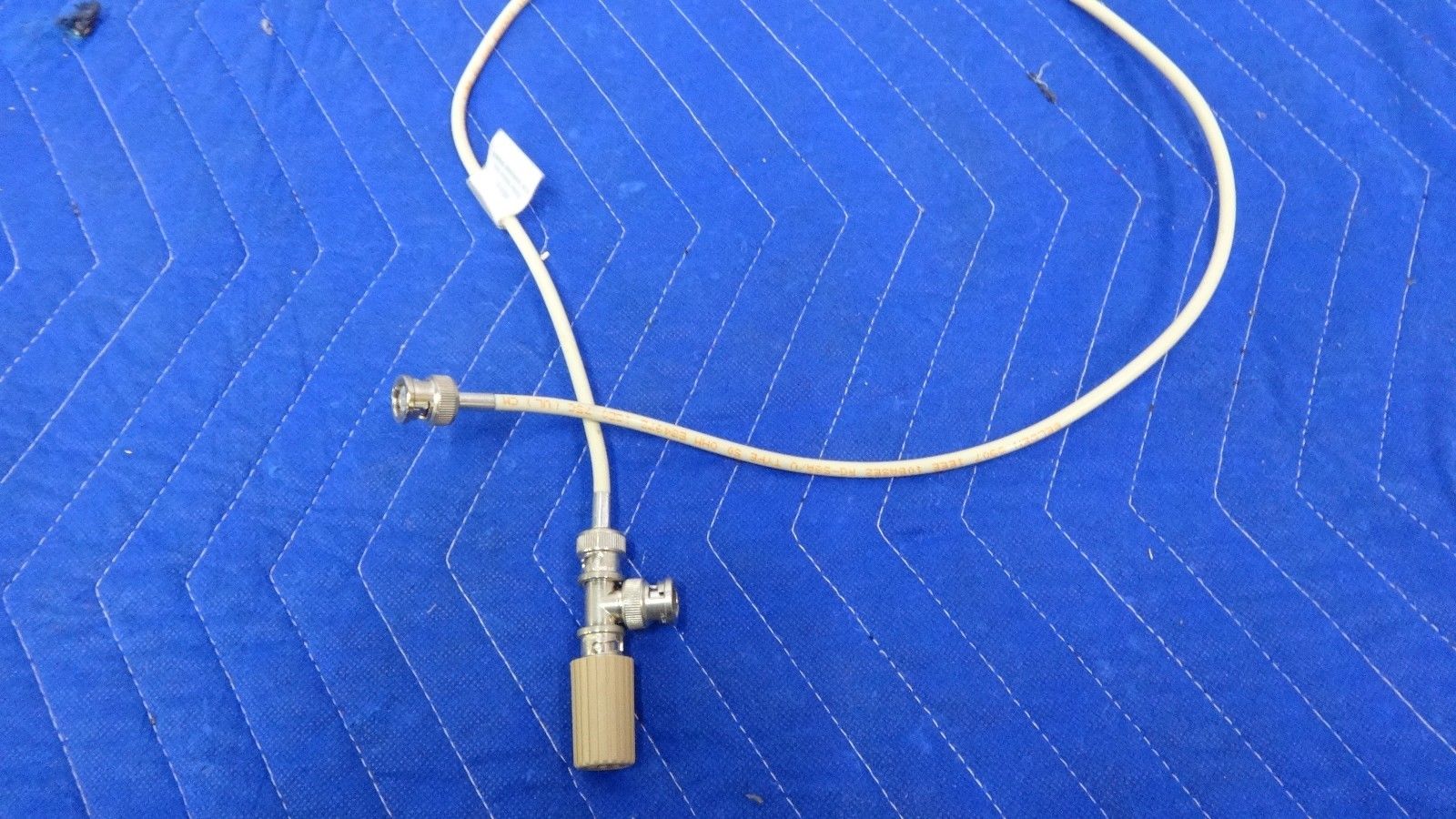 a white cord connected to a white device on a blue surface