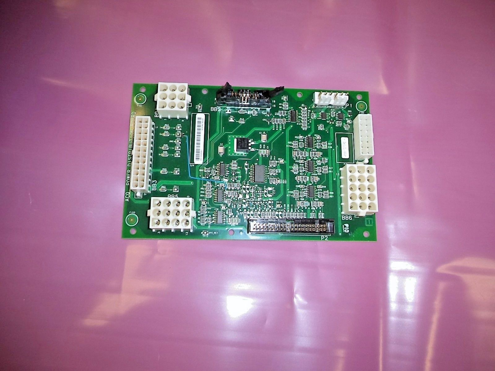 a green circuit board sitting on top of a pink table