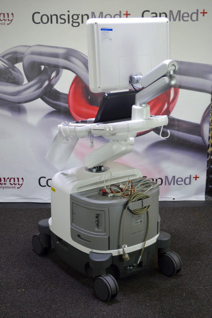 a medical device sitting on wheels in front of a sign